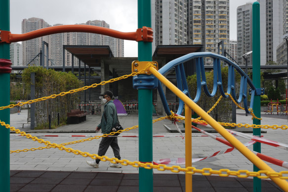 A man walks past a children’s playground cordoned off due to social distancing laws in Hong Kong on Sunday.