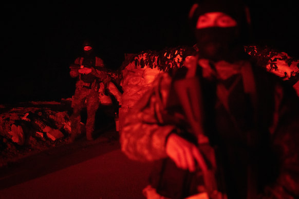 Ukrainian Territorial Defence Force members search vehicles after a curfew on a road on the outskirts of Kharkiv. Although Ukraine has repelled Russian forces elsewhere in the country, it expects a renewed attack from the east.