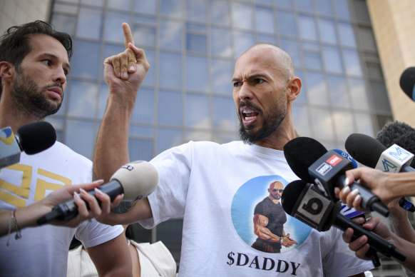 Andrew Tate speaks to media, next to his brother Tristan, left, outside the Bucharest Tribunal after being placed under house arrest.