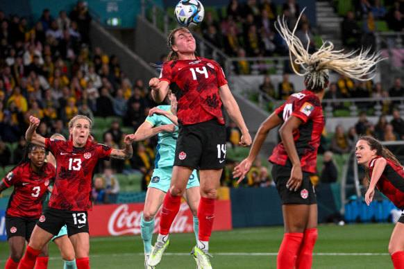 Vanessa Gilles of Canada heads the ball .