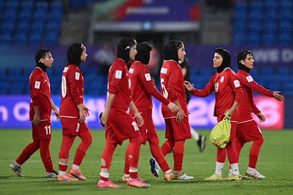 The Iranian team leaves the field after their defeat in their match against the Philippines at Gold Coast Stadium on Sunday night.