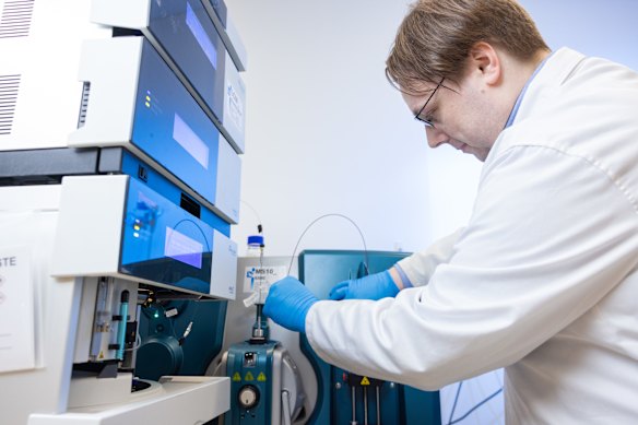 Proteomics research scientist Martin Mead adjusts a mass spectrometer column used for its proteomics diagnostics research in the company’s Perth laboratory.