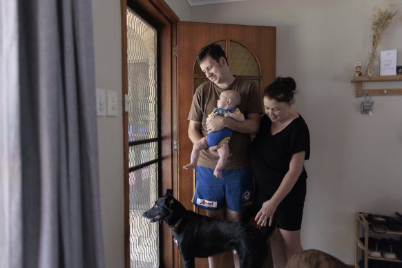 Adam and Naomi McGowen with their son Austin, three months, at their new home in Lismore Heights.