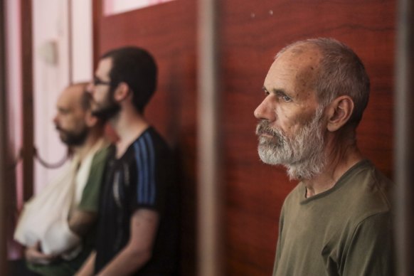 John Harding seen behind bars in a courtroom in Donetsk in August.