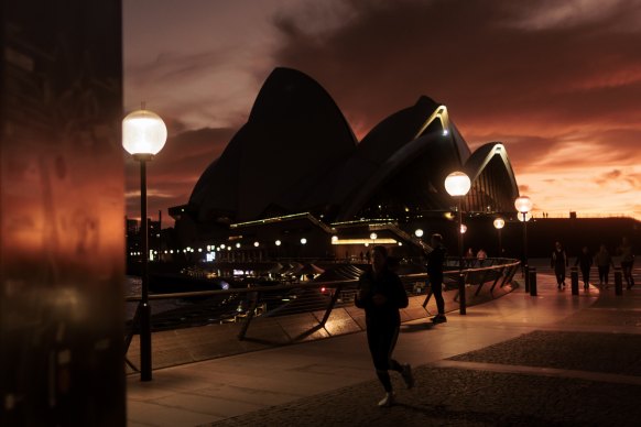 Dawn at the Sydney Opera House this morning with an afterglow caused by a Volcanic eruption in Tonga.
