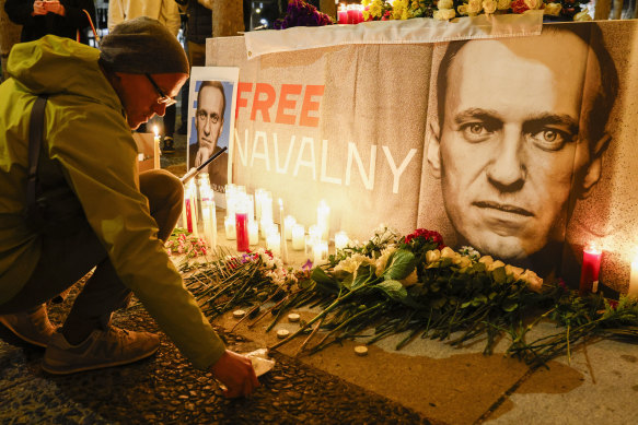 Pavel Shumilkin lights candles for a vigil held for Alexei Navalny outside City Hall in San Francisco on Friday night.