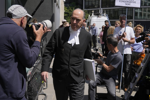 Andrew Green, the lead lawyer for Mirror Group Newspapers, passes by media at the High Court in London.