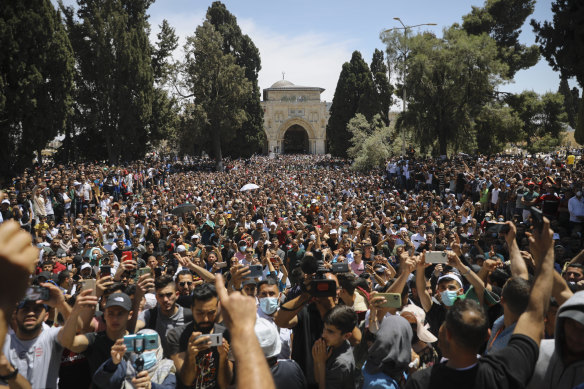 Worshippers protest against the likely evictions of Palestinian families from their homes in front of the al-Aqsa Mosque in Israeli-occupied East Jerusalem on Friday.