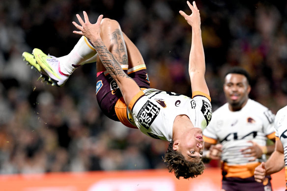 Reece Walsh celebrates his comeback try with some acrobatics.