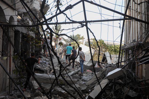 People survey the wreckage of homes destroyed in an Israeli airstrike on Khan Younis in Gaza on Wednesday.