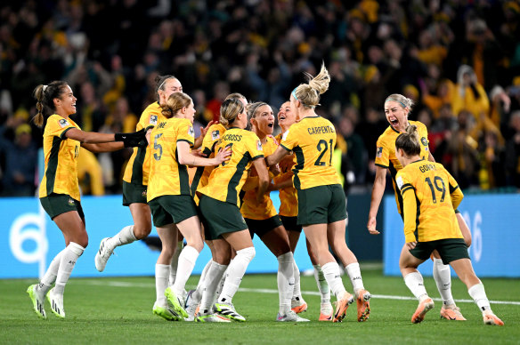 Australia celebrate at full-time in their first World Cup game.