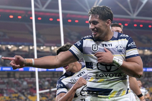 Murray Taulagi of the Cowboys celebrates after scoring a try.