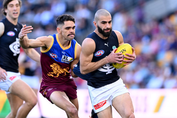 Adam Saad tries to give Brisbane’s Charlie Cameron the slip last season.