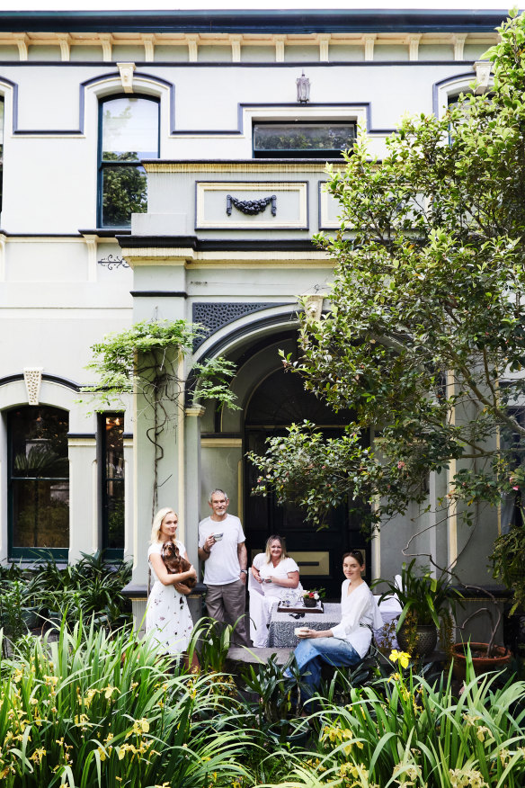 Isabella, holding Bowie, with Ross, Natalie and Sascha in the lush garden, which is planted with camellias, orchids, peonies and tulips.
