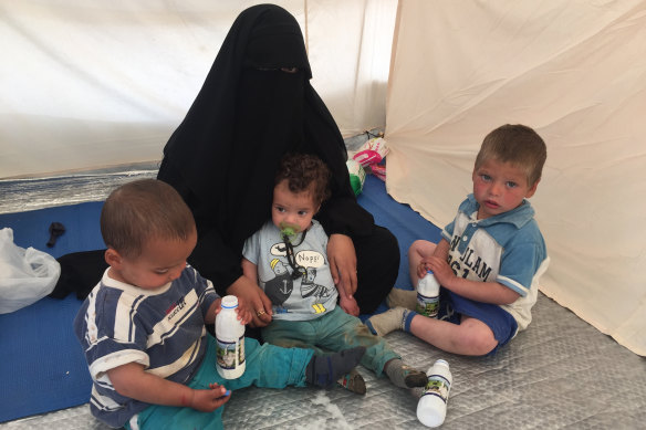 Shayma Assaad and her three sons in her tent at the al-Hawl camp.