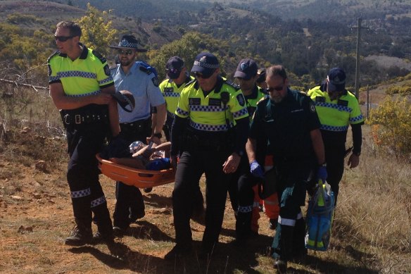 Emergency services help Kathleen Bautista to safety. She was found in a remote area of the Cotter near Canberra after seven days of being reported missing in 2015. 