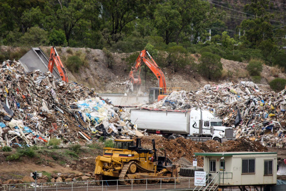 Hive of activity: At BMI Group's Swanbank recycling facility, the grey truck seen tipping on the left, which carries NSW plates, adds to a pile of unprocessed waste being loaded on to local trucks.