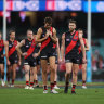 Essendon leave the field after the loss to Sydney.