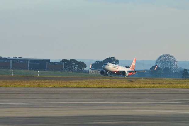 The Jetstar plane lands at the new Sydney airport.