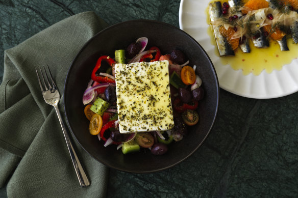 Horiatiki with tomato, cucumber, feta, olives and radishes.