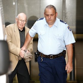 Roger Rogerson is escorted out of King St courts during his trial for murder in 2016.