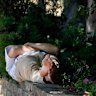A man finds shade in London. The British Met Office says temperatures won’t peak until next week.