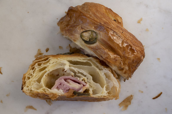 A ham and cheese croissant is
a fat pillow of pastry loaded with gooey cheese and a lolling fold of cured pink meat.