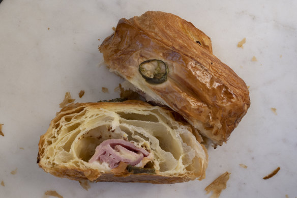 A ham and cheese croissant is
a fat pillow of pastry loaded with gooey cheese and a lolling fold of cured pink meat.