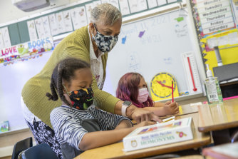 Elementary school students wear masks in class at a school in Oakland, California. 