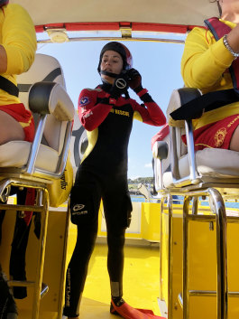 Fiona Phelps prepares to jump in the water to demonstrate a sea-based rescue. 