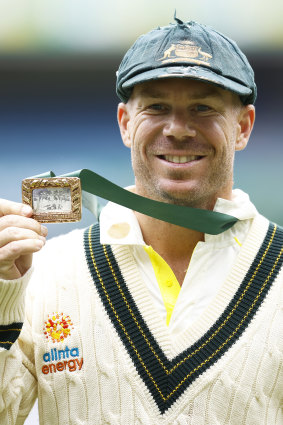 David Warner holds the Mullagh Medal after being awarded player of the match at the MCG.