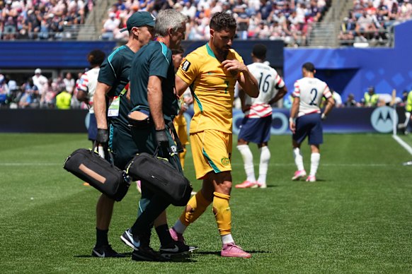Mathew Leckie walks off the pitch after injuring his hamstring.