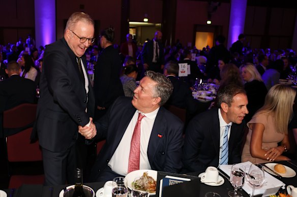 Prime Minister Anthony Albanese bestows a grip-and-grin on Westpac’s Anthony Miller.