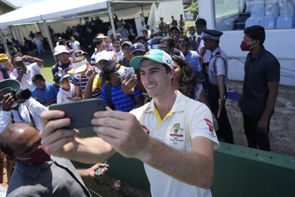 Pat Cummins takes a selfie with fans after Australia’s Galle victory.