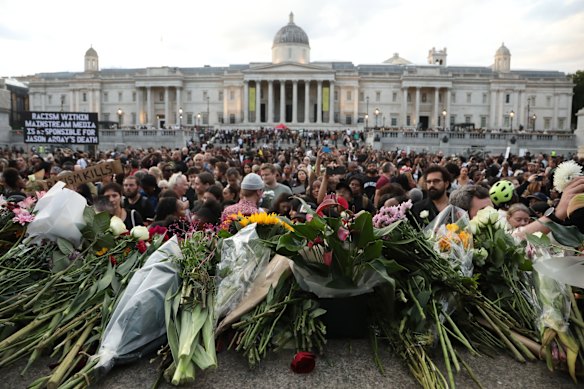 Flowers are laid during a vigil for former Cambridge professor Jason Arday in Trafalgar Square.