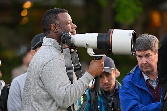 Ken Griffey Jr. stands with a camera at the Masters.