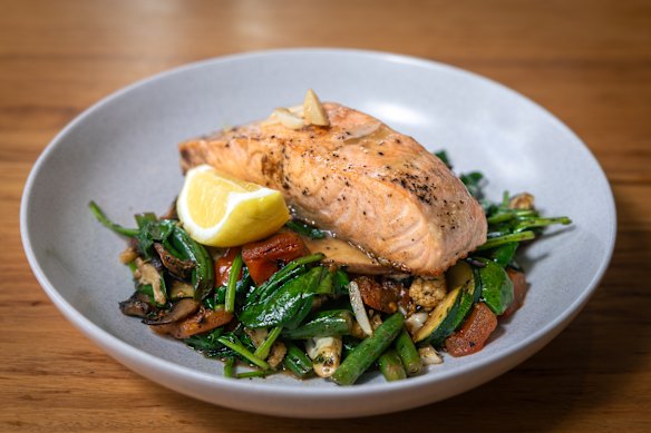 Baked salmon with the sauteed vegetables and lemon.