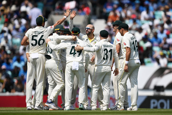 Nathan Lyon and his Australian teammates celebrate a wicket.