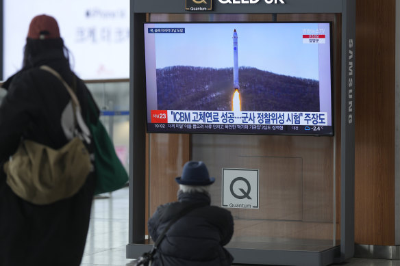 A TV shows a file image of North Korea’s rocket with test satellite during a news program at Seoul Railway Station on Saturday, December 31, 2022. 