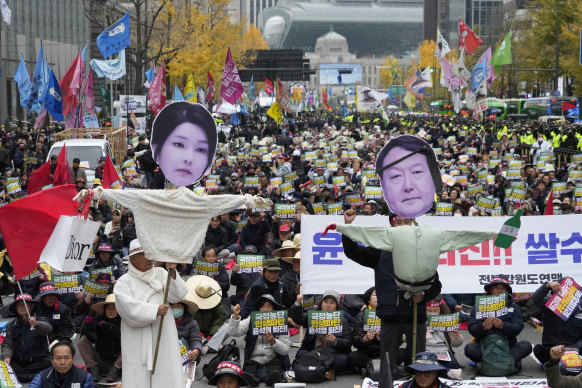 Members of the national federation of farmers, known as “Junnong”, and the Korean Confederation of Trade Unions, with effigies of South Korean President Yoon Suk Yeol (right) and his wife, Kim Keon-hee.