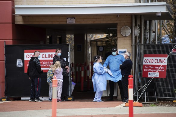 A family lines up to get tested outside the COVID clinic at Joondalup Health Campus.