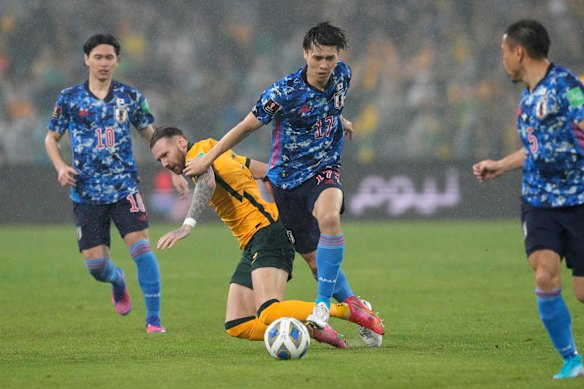 Japan’s Ao Tanaka plays the ball past Australia’s Martin Boyle.