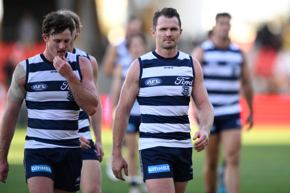 Patrick Dangerfield – flanked by Jed Bews (left) – leads Geelong off the ground after the third successive loss under his fledgling captaincy.