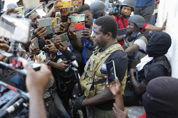 Jimmy Chérizier, a former elite police officer known as Barbecue who now runs a gang, speaks to journalists in Port-au-Prince.