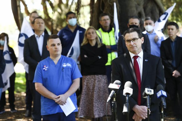 NSW Nurses and Midwives’ Association general secretary Brett Holmes with hospital emergency department nurse Josh who was diagnosed with COVID-19 and received workers’ compensation cover without having to prove he was infected at work.