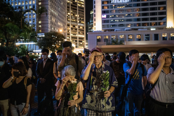 Protesters cover their left eyes and stand in silence during the 74th Liberation Anniversary Assembly  on August 30, 2019 in Hong Kong.