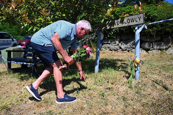 A man leaves flowers outside Widdecombe's home on Saturday.