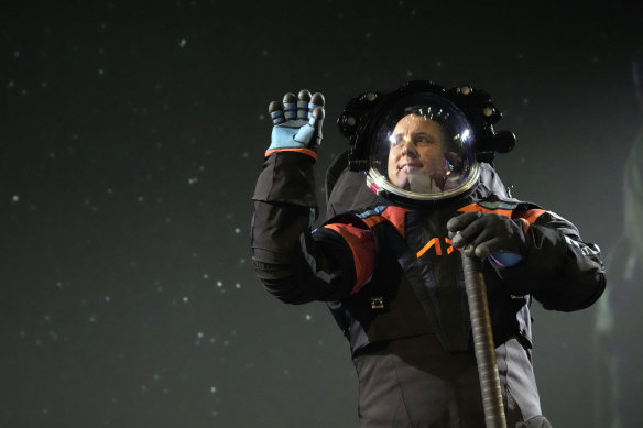 Axiom Space chief engineer Jim Stein demonstrates a prototype spacesuit. The company said the final version will be different, including the colour.