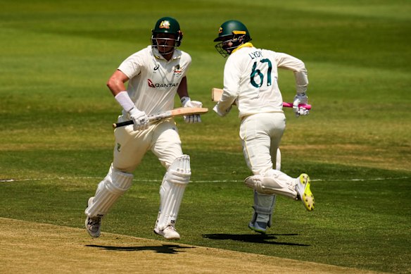 Australia’s Matt Renshaw, left, runs between the wickets with his teammate Nathan Lyon on day two.
