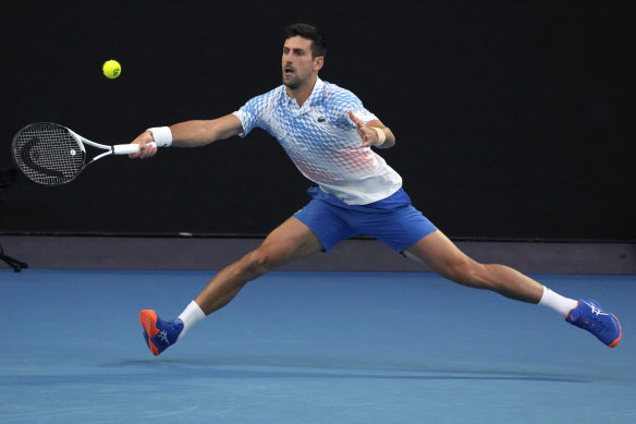 Novak Djokovic of Serbia plays a forehand return to Stefanos Tsitsipas.